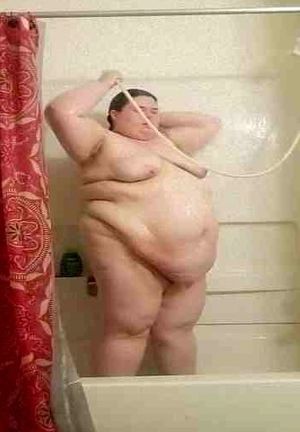Lovely bbw with a beautiful big belly showering.