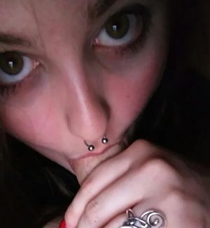 Close-up on a brunette with big doe-eyes sucking cock