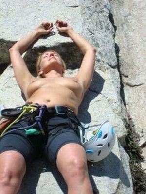 Topless sunbathing climber