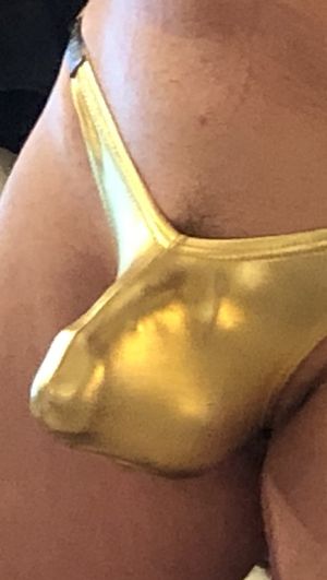 outline of firm head in gold thong