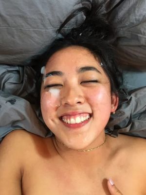 Happy amateur Asian chick with a facial