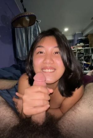 Asian smiling and giving head