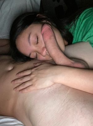 Amateur brunette resting a cock on her face as she goes down on a guy