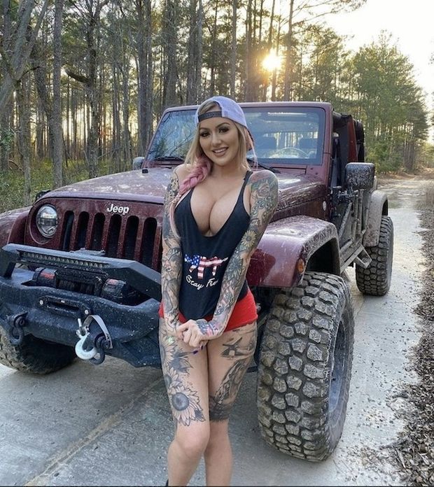 Hot tattooed chick with a monster car
