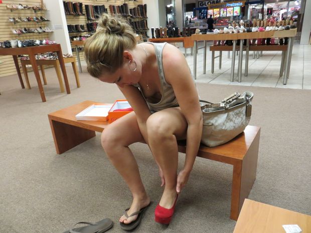 Braless MILF trying on a pair of shoes