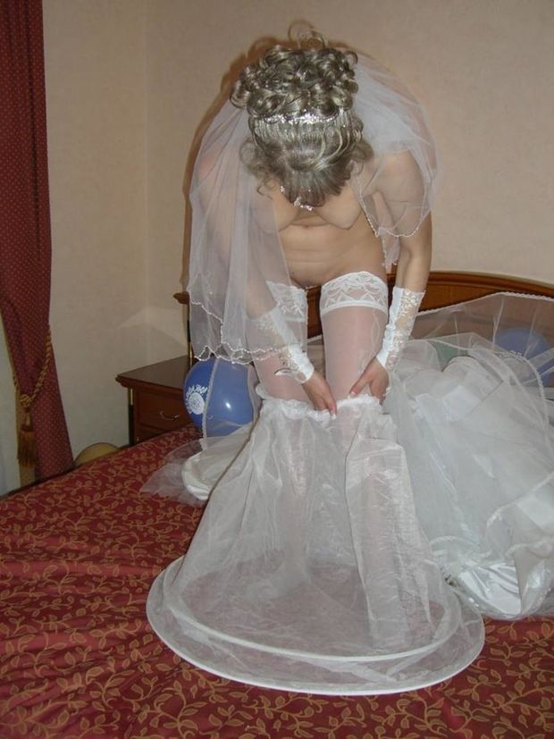 Taking the wedding dress off. Nice tits and pussy.