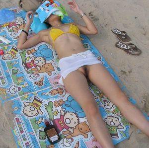 Hairy lady relaxing at the beach