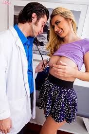 Natalia Starr lifting up her shirt as the doctor listen's to her heartbeat with a stethoscope.