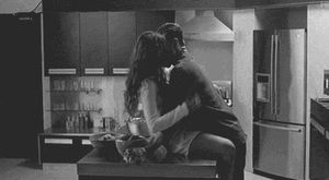 B&W couple making out while she's on the kitchen counter