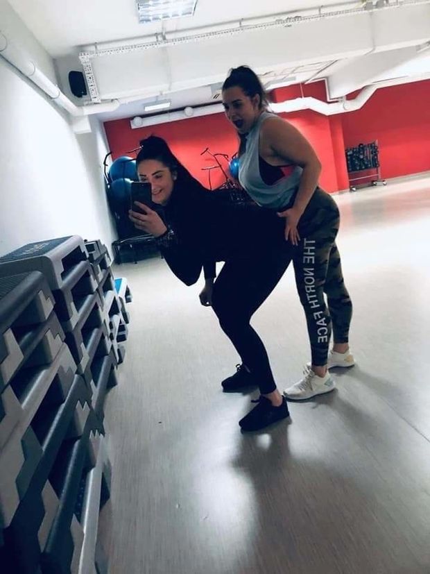 horny Kinga gets a spank from her friend at the gym
