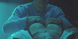 Unhooking her bra…