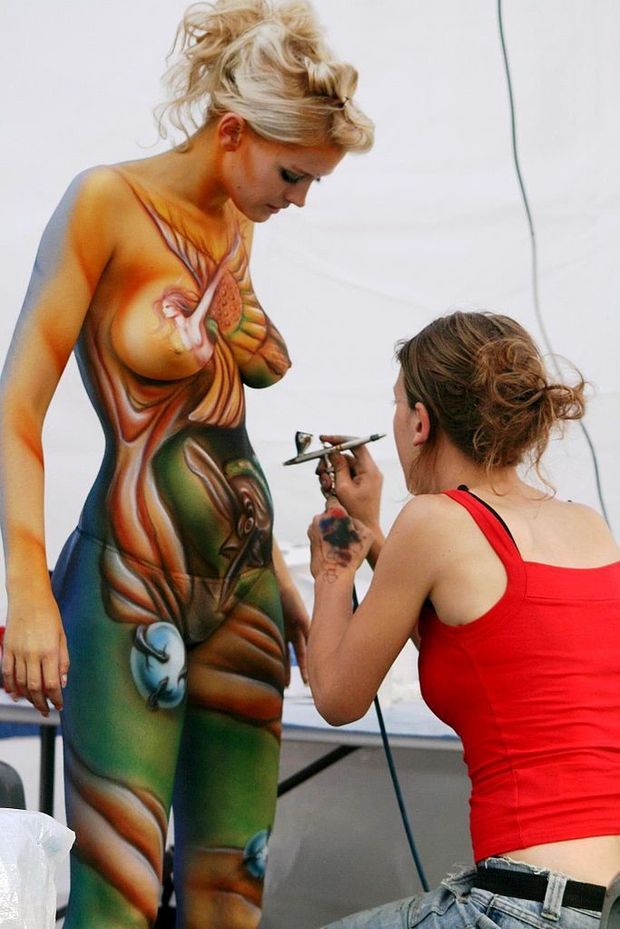 Blonde babe getting her body painted
