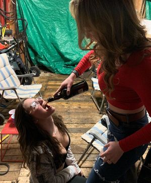 Abby feeding friend booze