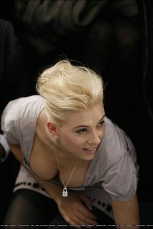 Hottie bent over showing off her firm breasts