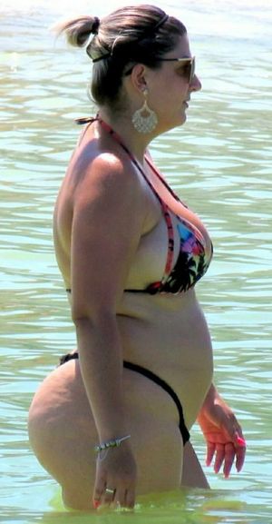 That tiny bikini fails to hide her curves...