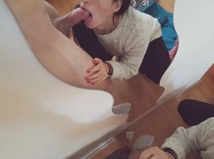 Mirror-shot of an amateur brunette sucking some cock