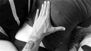 Squeezing her breast