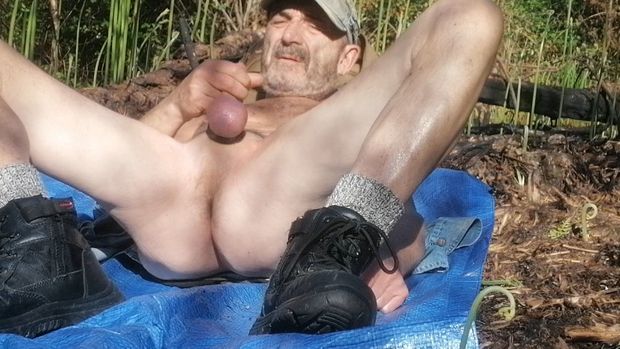 Male naked outdoors showing cock balls in public