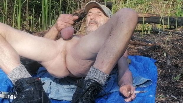 Male naked outdoors showing cock balls in public