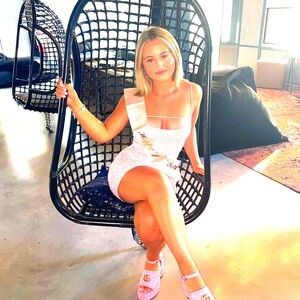 Pretty Emmerdale babe sitting in black chair