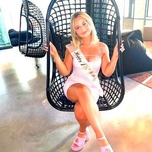 Pretty Emmerdale babe sitting in black chair pic 2