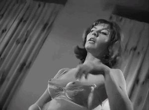 Vintage brunette takes off bra