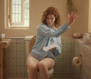 Redhead woman (Lisa O'Connor) sitting on the toilet without pants for a commercial. Slut, what you don't do to make money - Tena Discreet