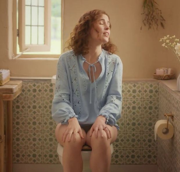Redhead woman (Lisa O'Connor) sitting on the toilet without pants for a commercial. Slut, what you don't do to make money - Tena Discreet