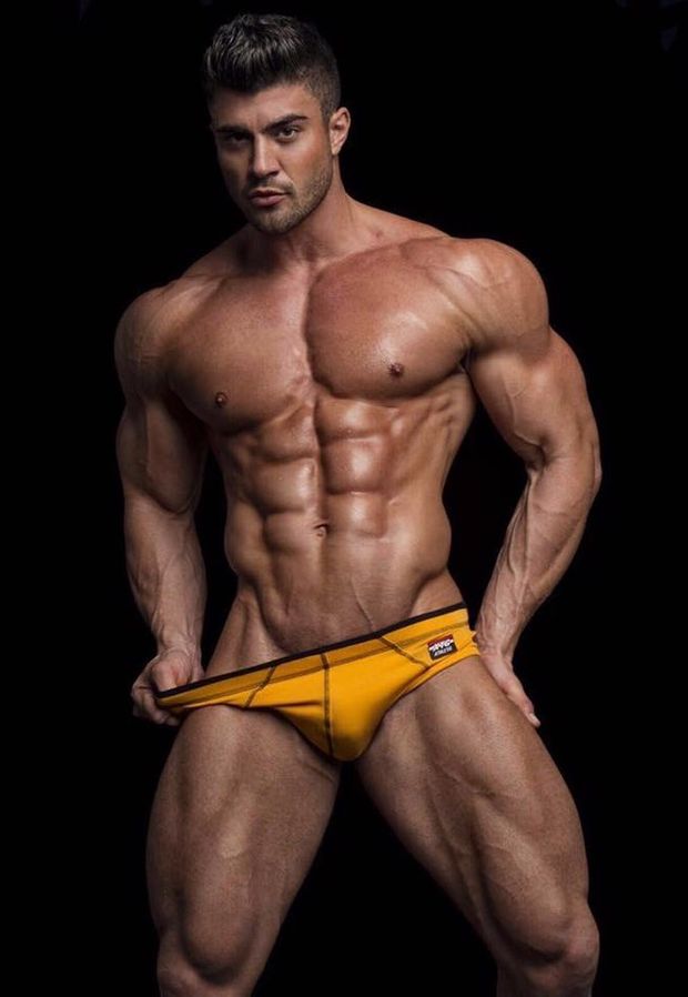 Muscled Man Posing in Yellow Speedo