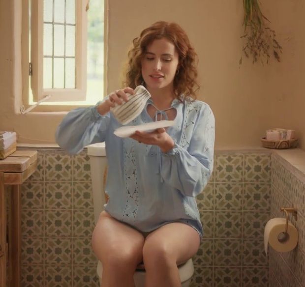 Redhead woman (Lisa O'Connor) sitting on the toilet without pants for a commercial. Slut, what you don't do to make money - Tena Discreet