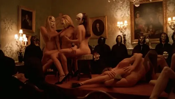 A very entertaining lesbian show for the public and a couple having sex in a 69 position - Eyes Wide Shut orgy