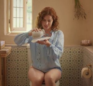 Redhead woman (Lisa O'Connor) sitting on the toilet without pants for a commercial. Slut, what you don't do to make money - Tena Discreet