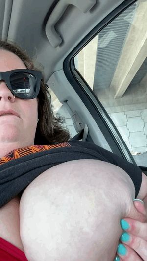 At a stoplight playing with my big titties