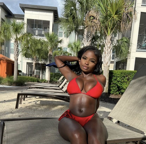 Dark skinned beauty looking cute in her bikini