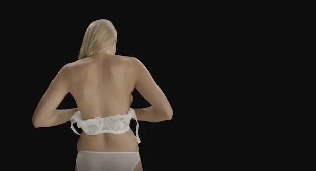 She fastening her bra