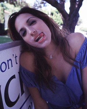 Brunette with cum on her face.
