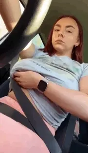 Flashing her tits in the car