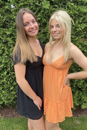 Blonde and brunette orange dress