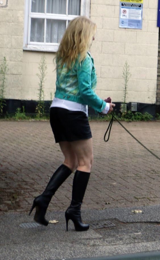 Hot MILF in boots taking her dog for a walk
