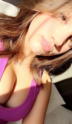 Teen in the sun showing cleavage pink top