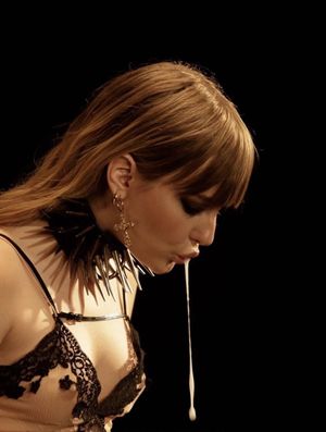 Lubing up the strap-on.