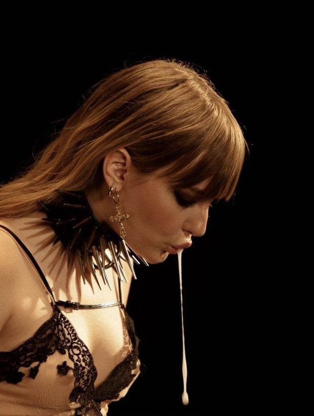 Lubing up the strap-on.