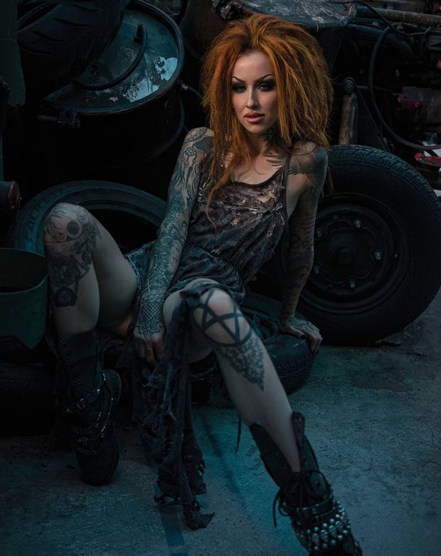 Slutty redhead thrasher whore, squatting in a junkyard, psyching herself up, for an impending gangbang.