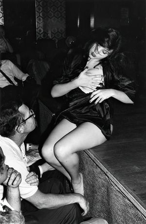 Kandi sitting on the stage at one of the New York theaters getting ready to service some of the audience