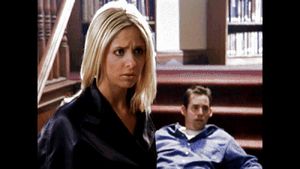 Buffy - looking hot, very angry looking hot as hell in sexy, black raincoat thinking Xander two timing her with other female student, Amy!