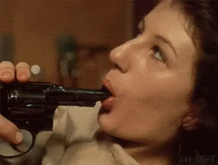 Sharon Mitchell giving head to a gun nut