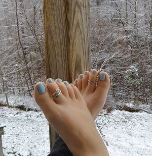 Beautiful Feet with Blue Nail Polish and Toe Rings
