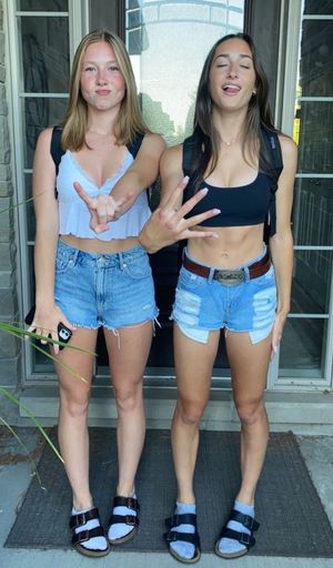 Blonde and brunette teen on door step