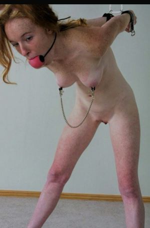 Jessica winces as the kidnapper contorts her body in strange positions for his own pleasure.