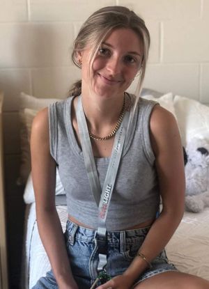 Victoria sitting on bed